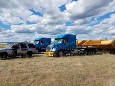 Pilot car and semi trucks on the road
